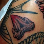 Small shark tooth tattoo