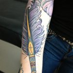 Neotraditional feather pen tattoo