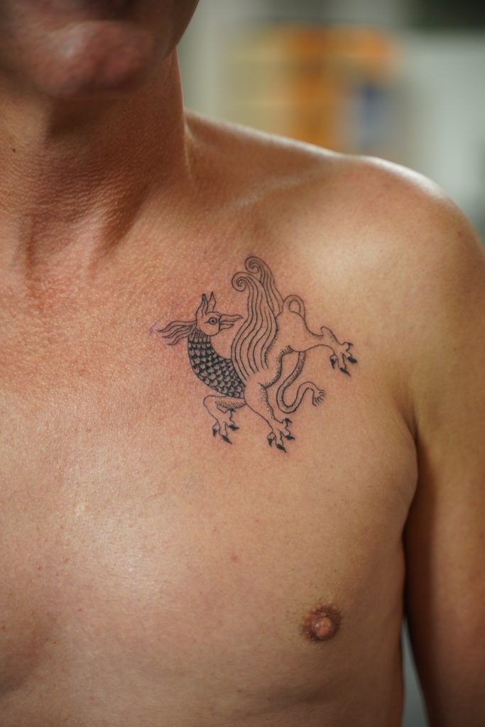 Werner’s mythical creature chest tattoo, tattooed by Roos